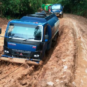 TERJEBAK. Sejumlah mobil angkutan yang terjebak di dalam kubangan lumpur di jalan Provinsi antara Sayan ke Kota Baru (1)