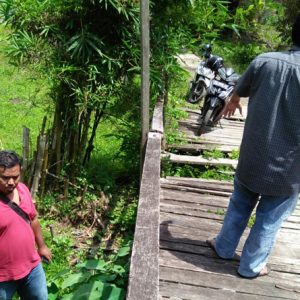 Warga sedang melihat kondisi jembatan sungai Ayau yang memprihatinkan